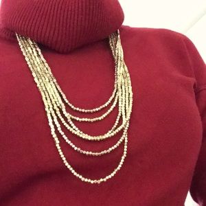 Six strand necklace of copper and gold beads